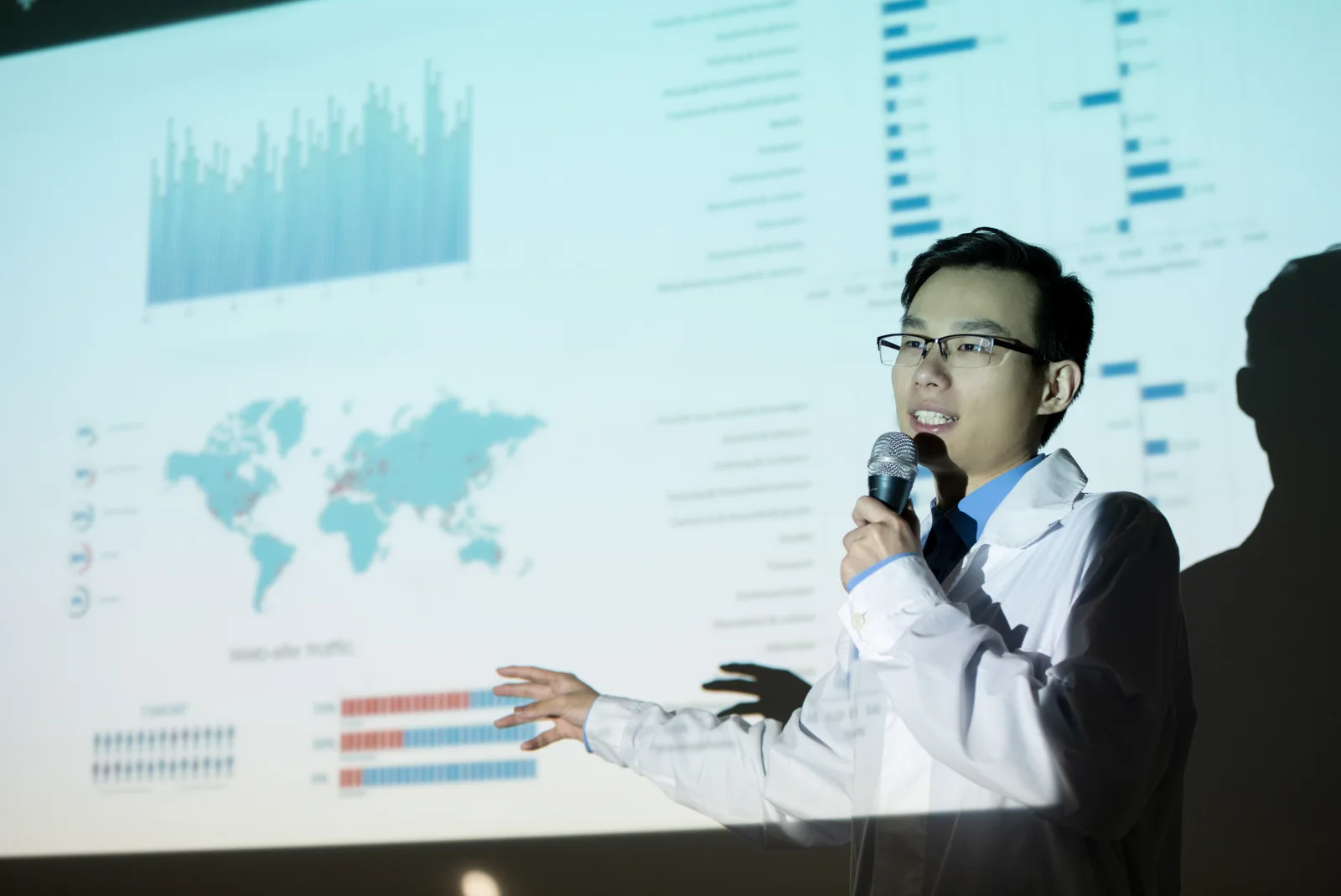 Illustrative photograph of a researcher presenting data to an audience