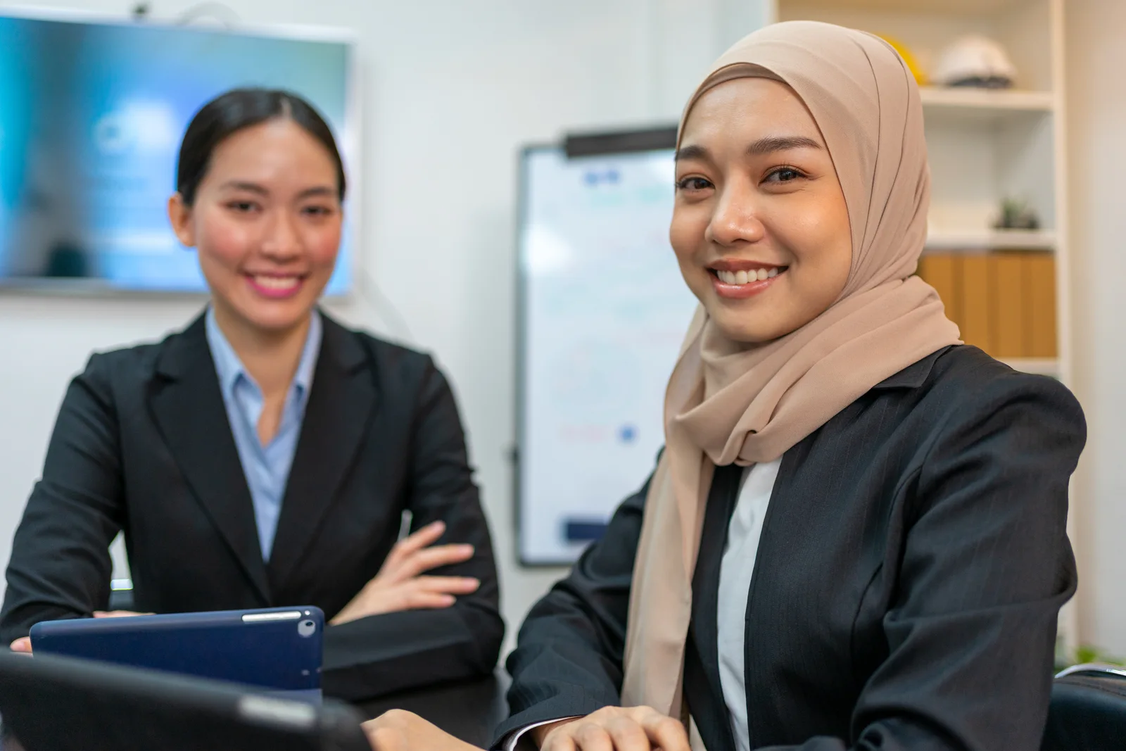 Two professionals collaborating in an office